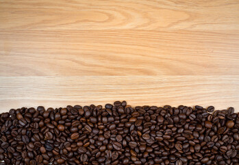 Roasted coffee beans  on brown wooden background. copy space