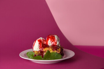 Delicious grated strawberry pie with vanilla ice cream balls, poured with strawberry syrup on a delicate pink background.decorated with a sprig of fresh mint. close-up. selective focus. copy space