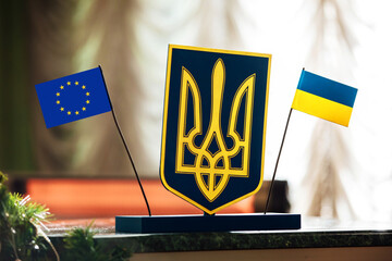 meeting Ukraine and European Union. Emblem of Ukraine: flag of blue and yellow colours, trident and...