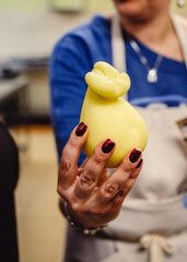 Italian cheese caciocavallo has just been made. Pears of caciocavallo cheese in hand.