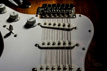 Electric guitar in the dark. Image of an electric guitar in the dark. Electric guitar chords closeup. Musical background