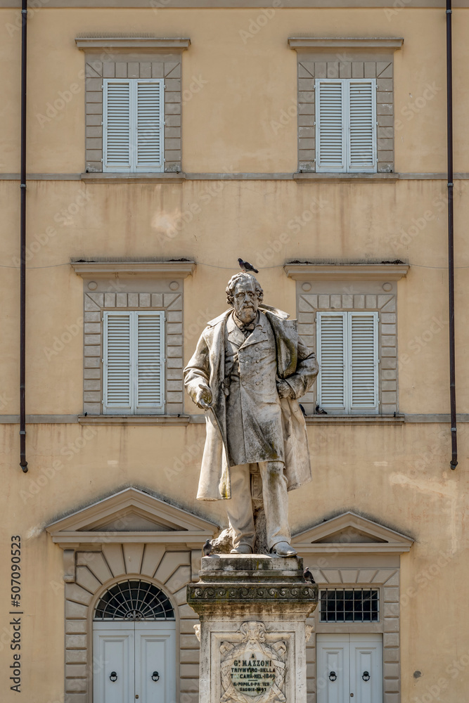 Wall mural the monument to giuseppe mazzoni in the old town of prato, italy, with a pigeon on the head