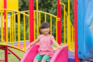 Portrait image of 4-5 years old childhood. Happy Asian child girl playing with the slider bar toy...