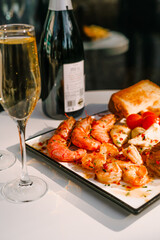 shrimp dinner with champagne on a plate