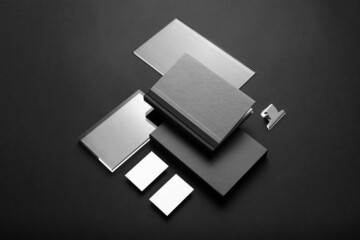 Obraz premium Black branding stationery mockup template, with trendy reeded glass elements, real photo, notebook, packaging, business cards. Blank isolated on a black background to place your design