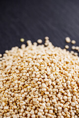 white quinoa seeds on a dark rustic background