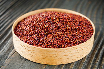 red quinoa seeds on a dark rustic background