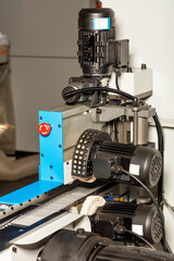 Industrial polishing machine with cloth wheels and tape drive.