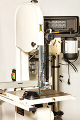 Vertical band saw woodworking machine for precise material processing.