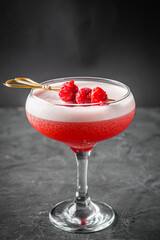 bright colored alcoholic cocktail on a black stone background