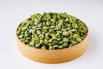 dried green peas on a white acrylic background