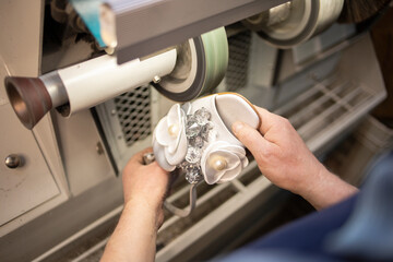 a man restores women's shoes on the machine. workflow, indoor shoe repair machine. Restoration of women's shoes, private business.