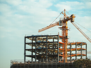 Fototapeta na wymiar Building under construction, cranes and high-rise building