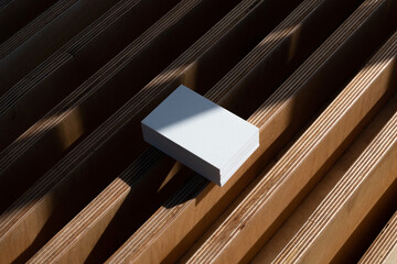 White business card, natural light photo mockup in urban outdoor environments with deep sunlit...