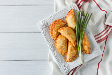 Fried chebureks, close-up, on a light background, no people,