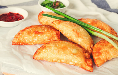 Fried chebureks, close-up, on a light background, no people,