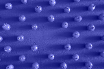 Tomatoes cherry, scattered in a chaotic manner on a Purple Background. Food background, design. Trendy Image, Toned in Color of the year 2022, Very Peri.