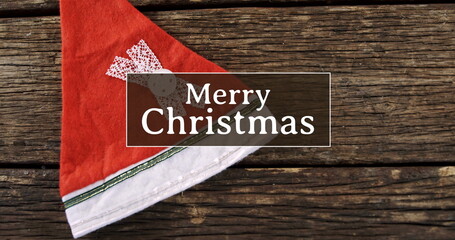 Fototapeta na wymiar Merry Christmas text and Santa hat