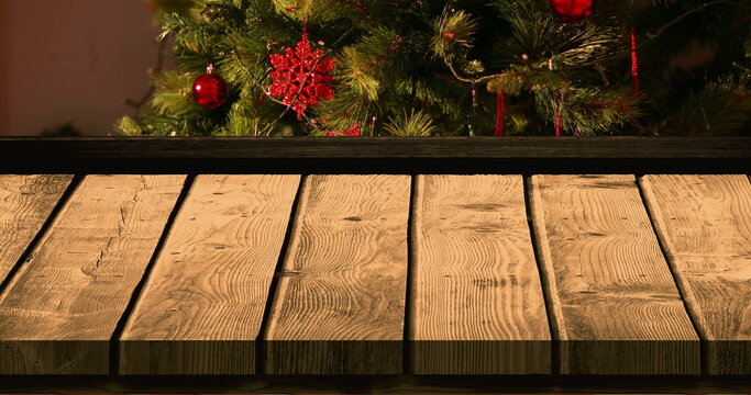 Wooden foreground with Christmas background of tree