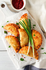 Fried chebureks, close-up, on a light background, no people,