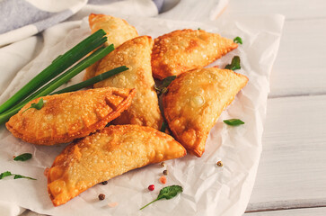 Fried chebureks, close-up, on a light background, no people,