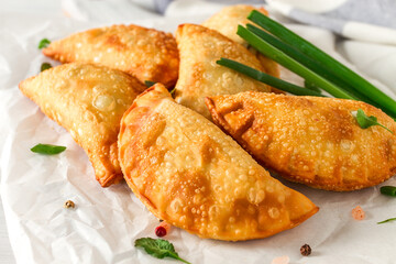 Fried chebureks, close-up, on a light background, no people,