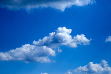Naklejka na ściany i meble Small clouds in the blue sky