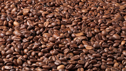 Closeup of many roasted coffee beans.