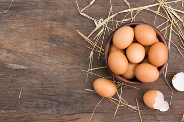 Chicken eggs in a wooden bowl Farm fresh organic eggs laid on a rustic wood