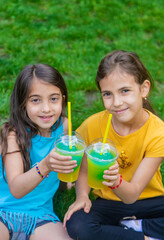 children drink a cocktail in the park. Selective focus.