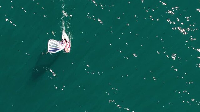 Bird's eye view of windsurfer learning to windsurf