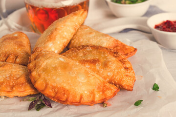 Fried chebureks, close-up, on a light background, no people,