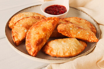 Fried chebureks, close-up, on a light background, no people,