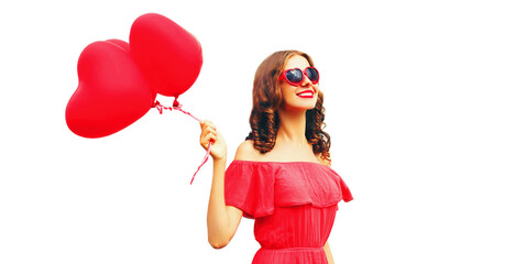 Portrait of happy smiling woman with red heart shaped balloon wearing sunglasses isolated on white background