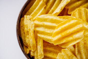 golden crispy potato chips on a white background