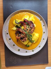 Beautiful dish with octopus, cassava and special sauce very colorful and beautiful