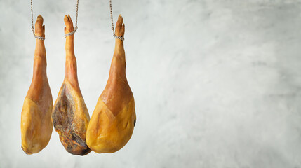 Spanish cured ham hanging against gray background. Copy space