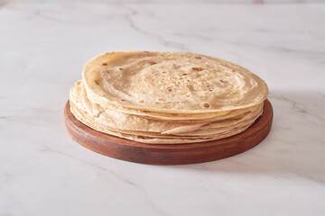 Stack of homemade whole wheat flour tortilla on plate