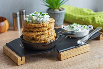 Oatmeal fritters with soft curd sauce with cucumber and herbs