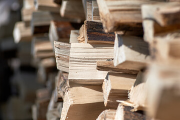 Firewood background - chopped firewood on a stack.