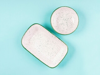 Two empty plates on turquoise background, copy space