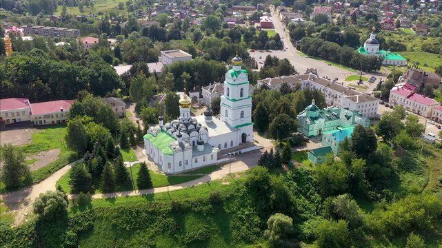Orbit drone shot of Troitsky cathedral (1674-1676) and Vyazma town on sunny summer day. Smolensk Oblast, Russia.