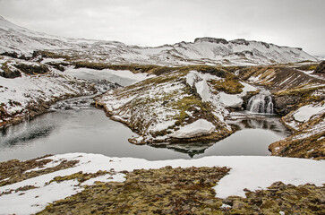 Snowy landscape with a twin waterfall in the mountains above Olafsvik in Iceland