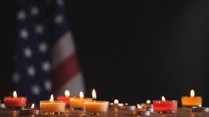 Happy Memorial Day, Man hand lighting memorial candle on American USA flag dark background. Concept...