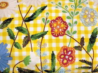 Floral embroidery design on white and yellow gingham with beads