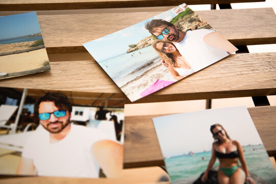 several photos of a couple in love on their summer vacations, on the beaches of Mallorca. on a wooden table with holes in it.
