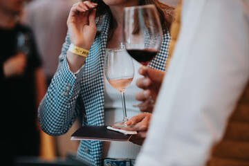 We celebrate success with a glass of white wine and champagne in hand at a special tasting with happy people.