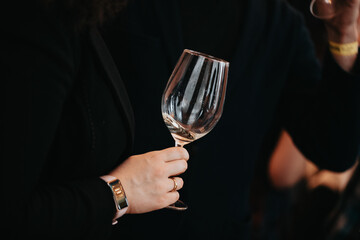 We celebrate success with a glass of white wine and champagne in hand at a special tasting with happy people.