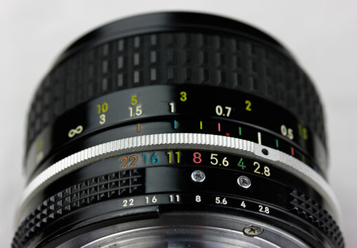 A vintage analog photo camera lens from the 90s for 35mm film with 50mm manual focusing mechanical lens made in japan professional photography black metal apperture 2.8 high quality close up macro