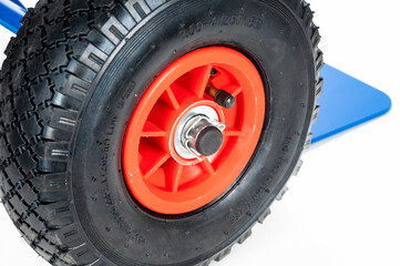 Wheels and platform of a blue cargo trolley, on the white background
